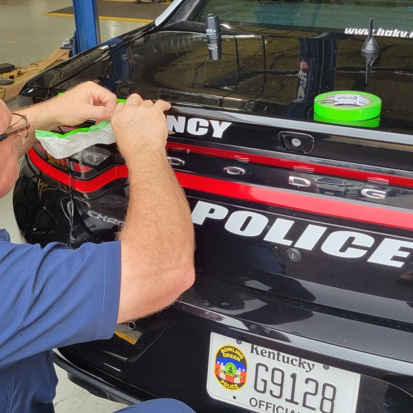 Service Technician David Long letters a BGPD cruiser