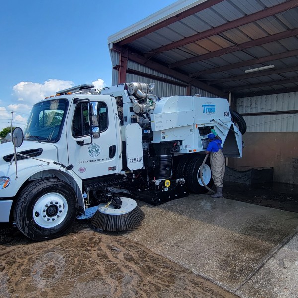 Operations Maintenance Technician III Tommy Burris cleans the sweeper after a long day (2 July)